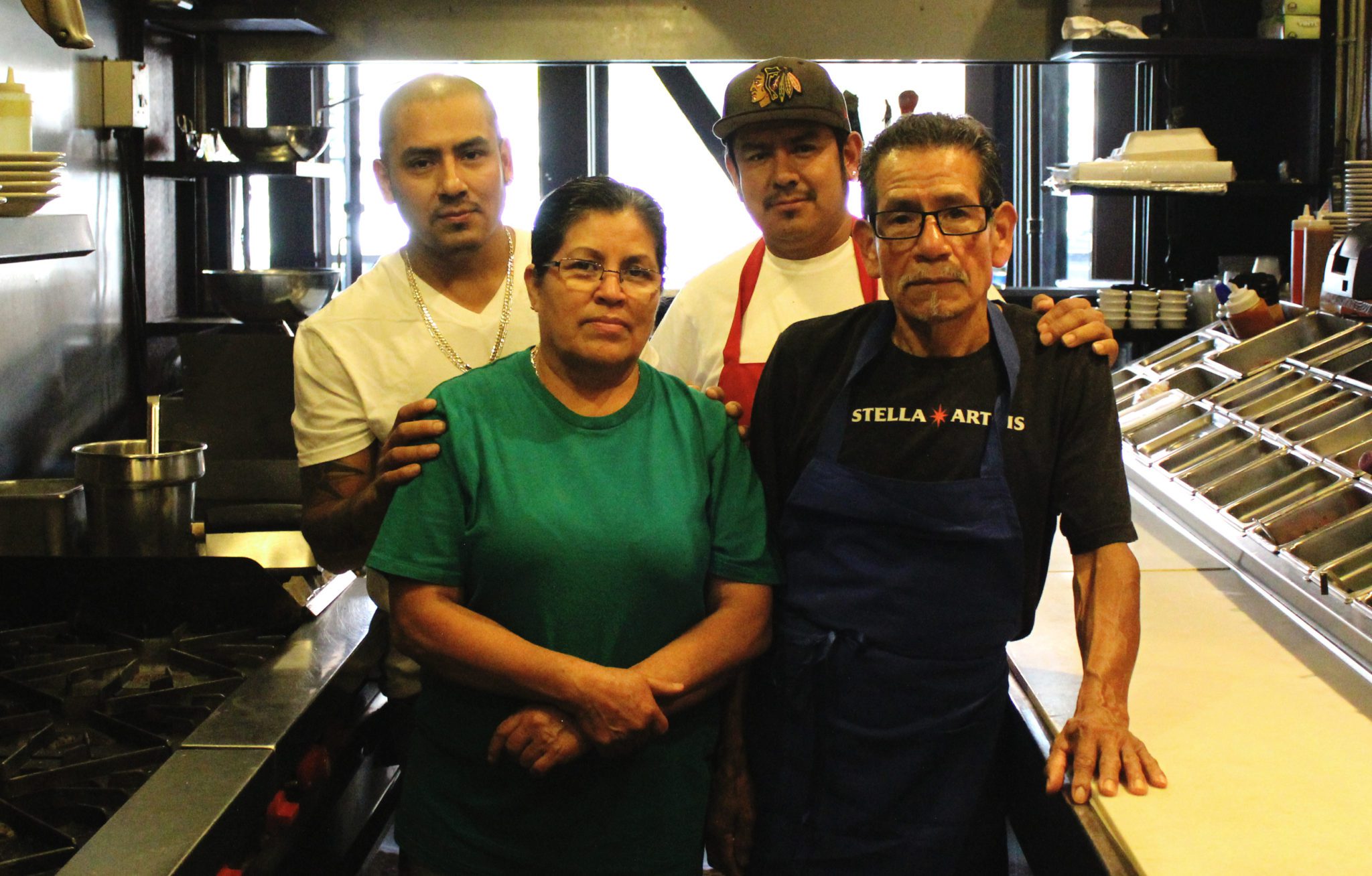 Villa Esondida owner Jose Perez and family members in the restaurant kitchen.