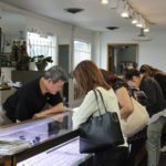 Owner Pham Lang helping customers at Bich Kieu Jewelry