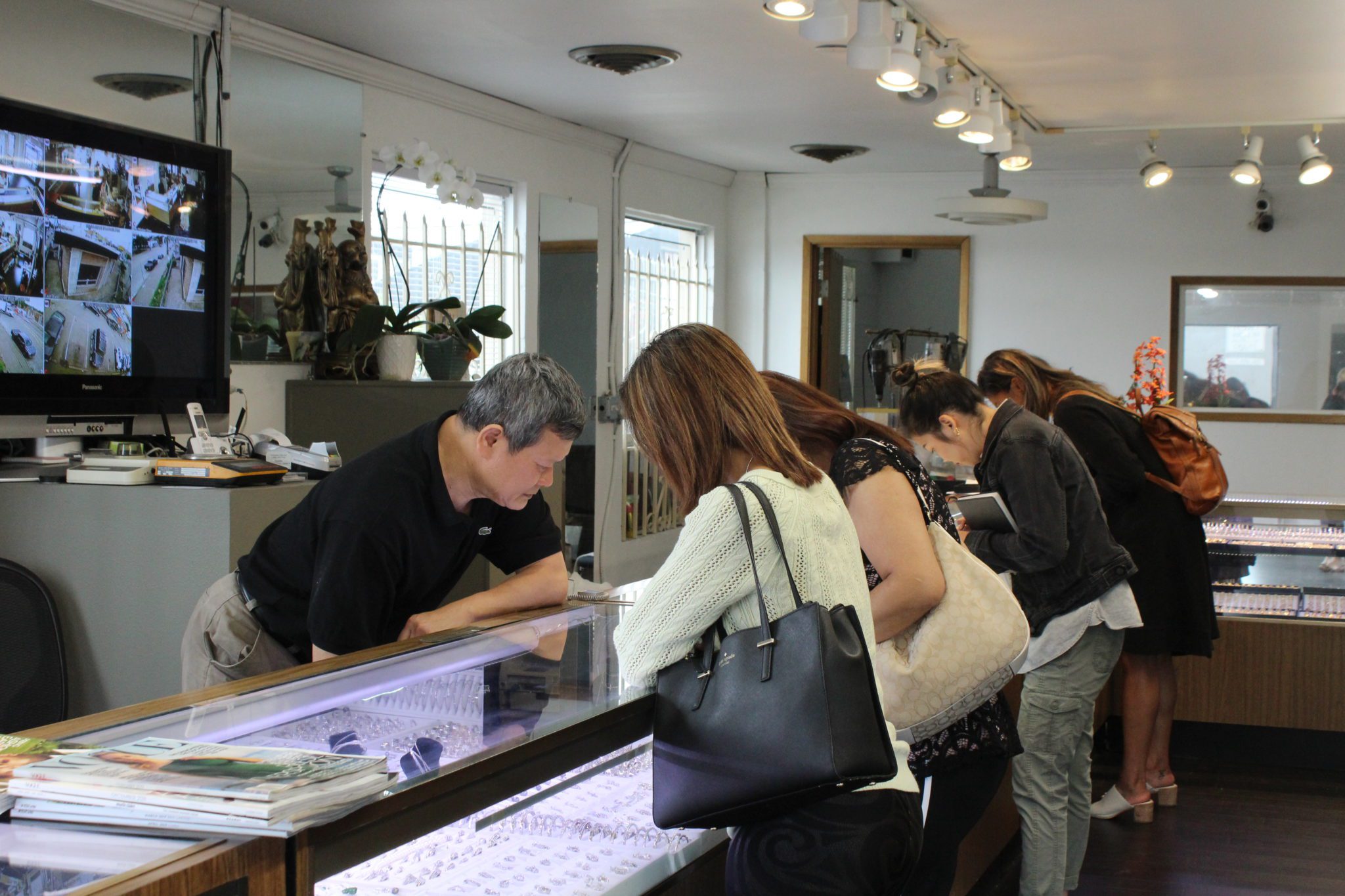 Owner Pham Lang helping customers at Bich Kieu Jewelry