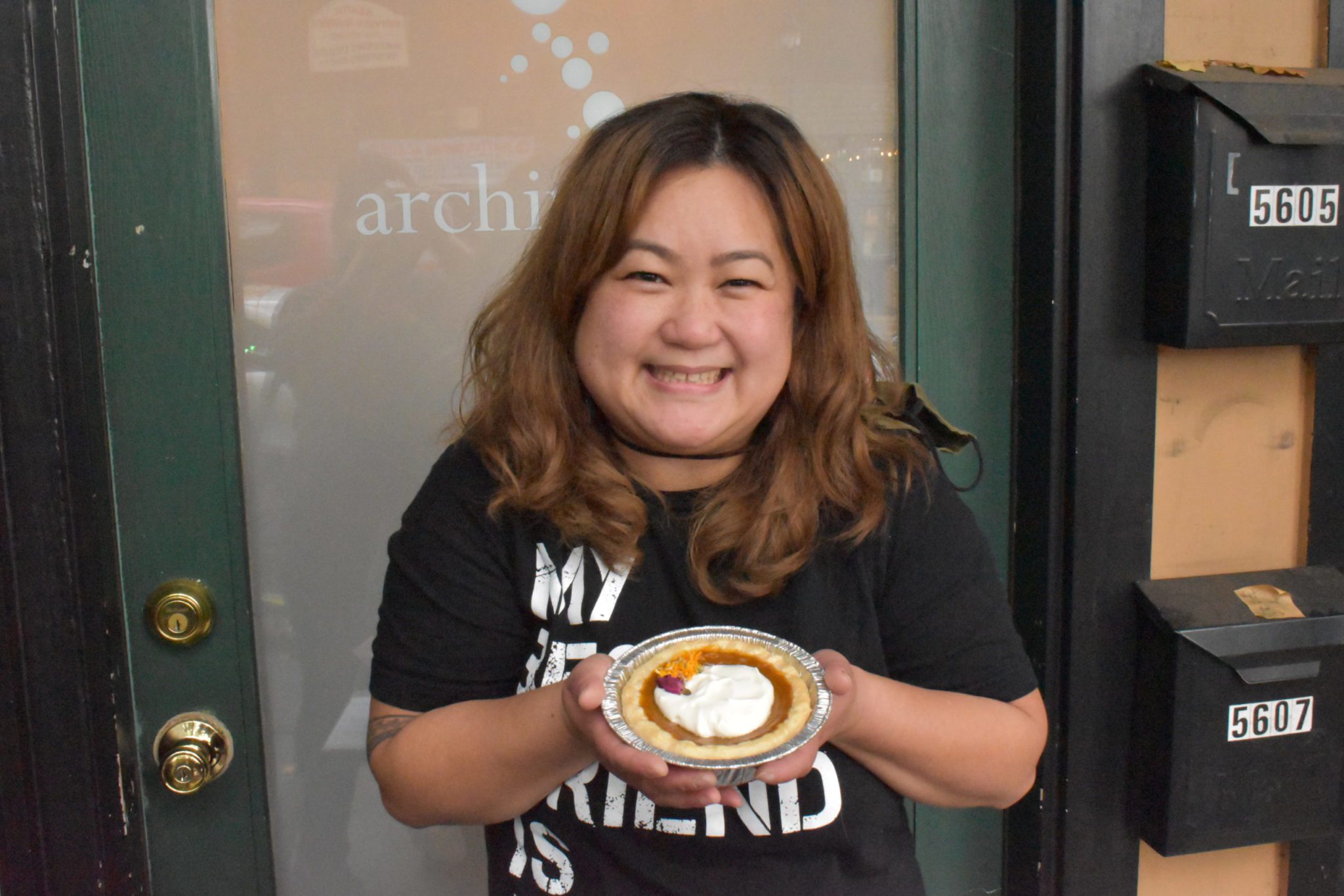 greyseas pies owner, Gracie Santos, posing with her kalabasa pie.